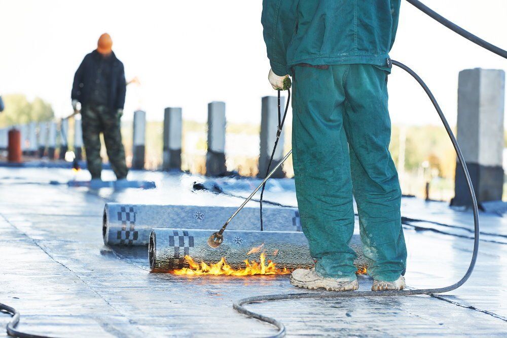 Photograph of two Roofers in Mobile, Alabama, finishing up an EPDM flat roofing project