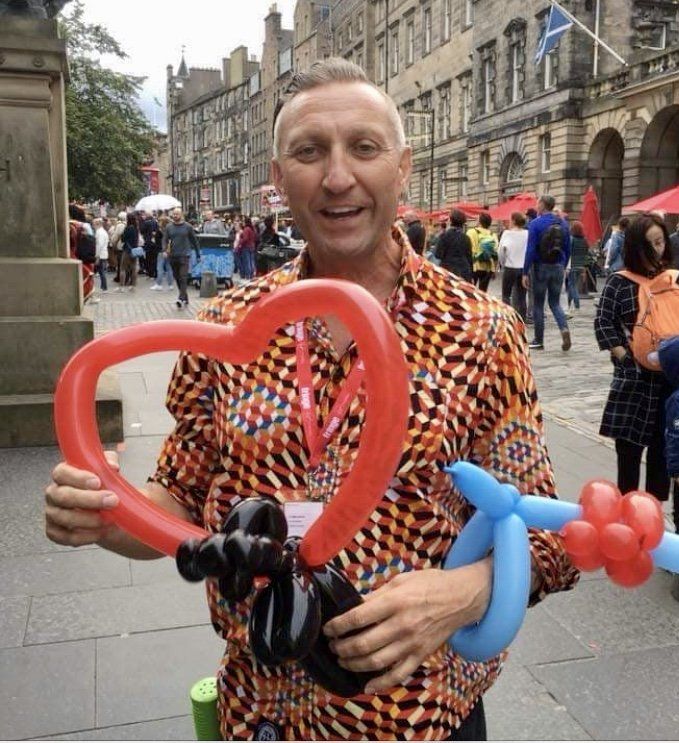 Balloon Animal Making by Clown Performer at Family Birthday Party