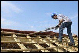 a roofing contractor replacing an old roof on a home in San Antonio, TX