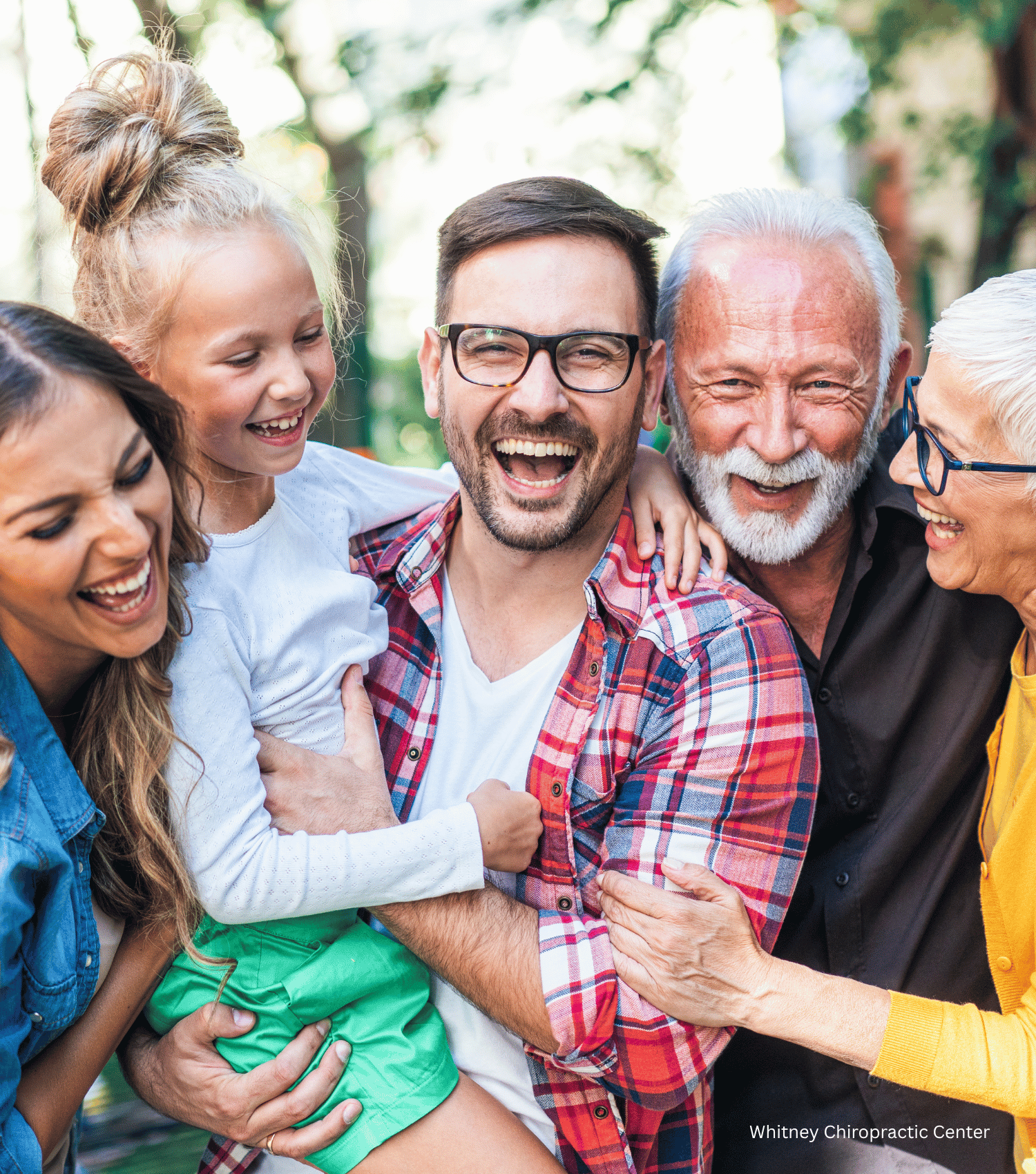 A group of people are posing for a picture together and laughing.