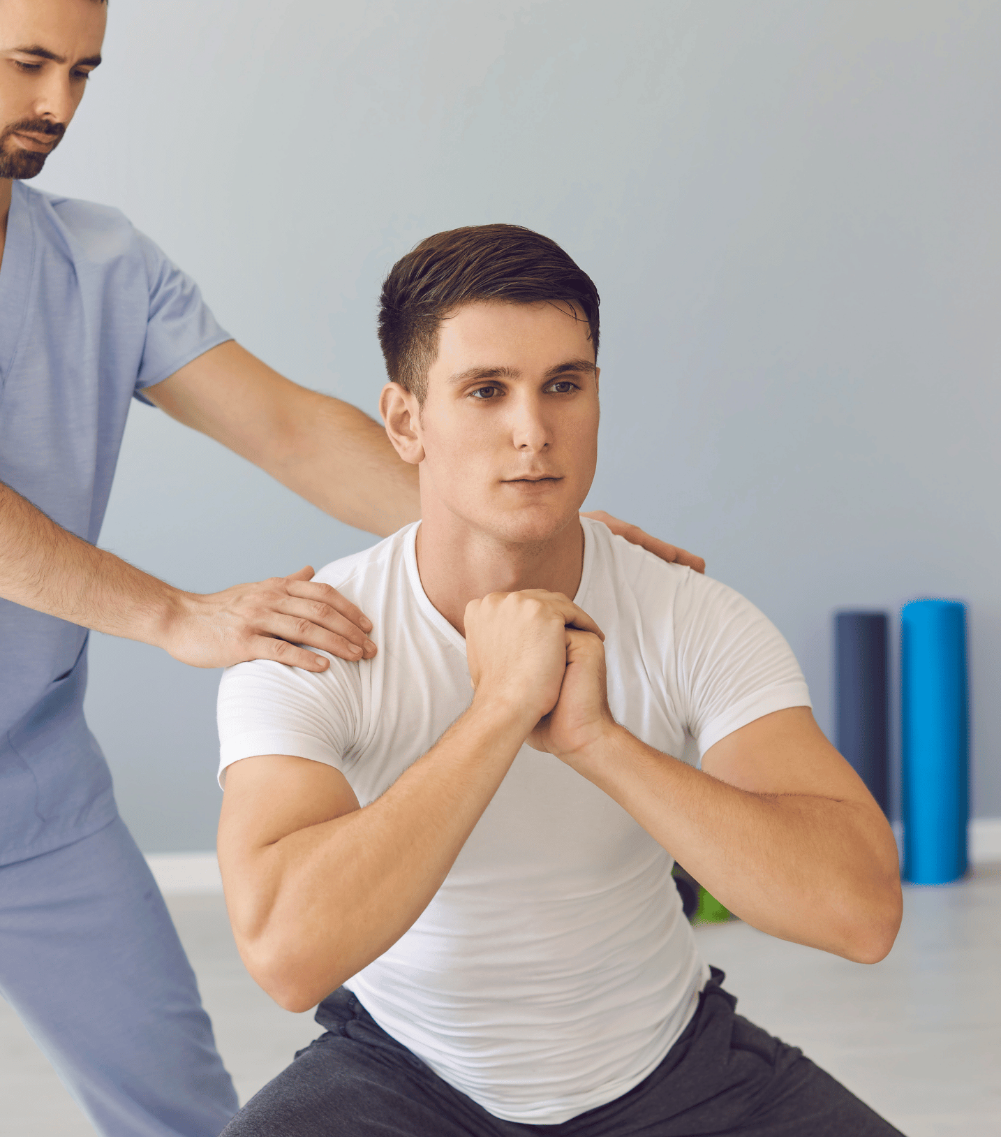 A man is doing squats with a nurse helping him.