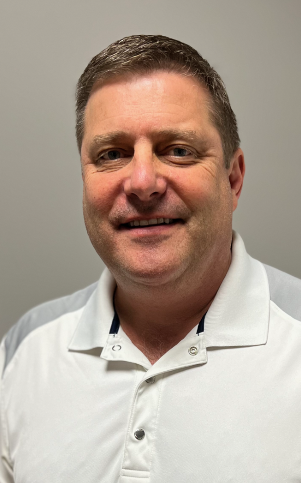 A man in a white shirt is smiling for the camera.