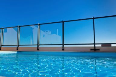 outdoor pool with glass wall