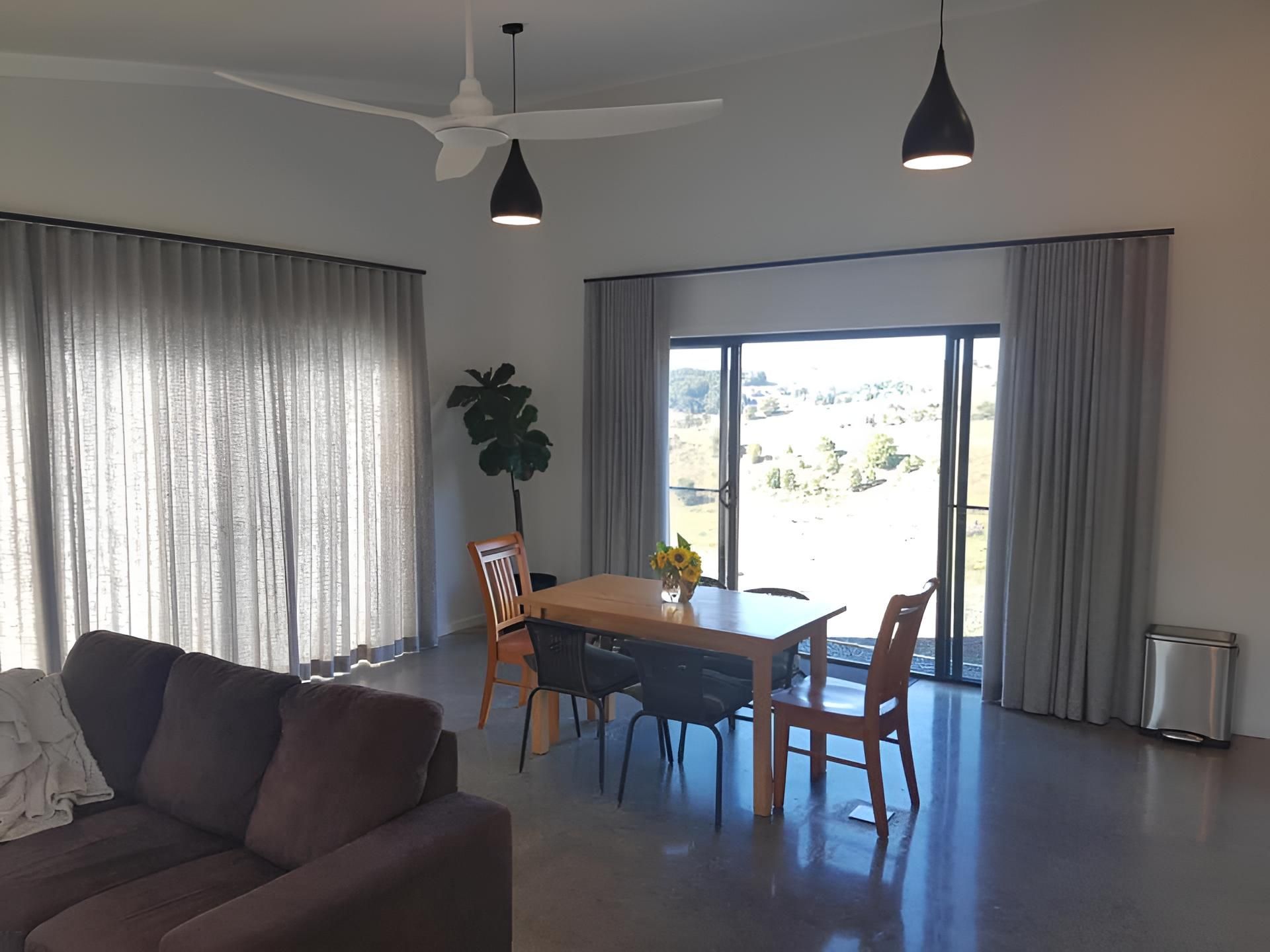 A Living Room With a Couch, Table and Chairs — Lismore Curtains & Blinds In Ballina, NSW