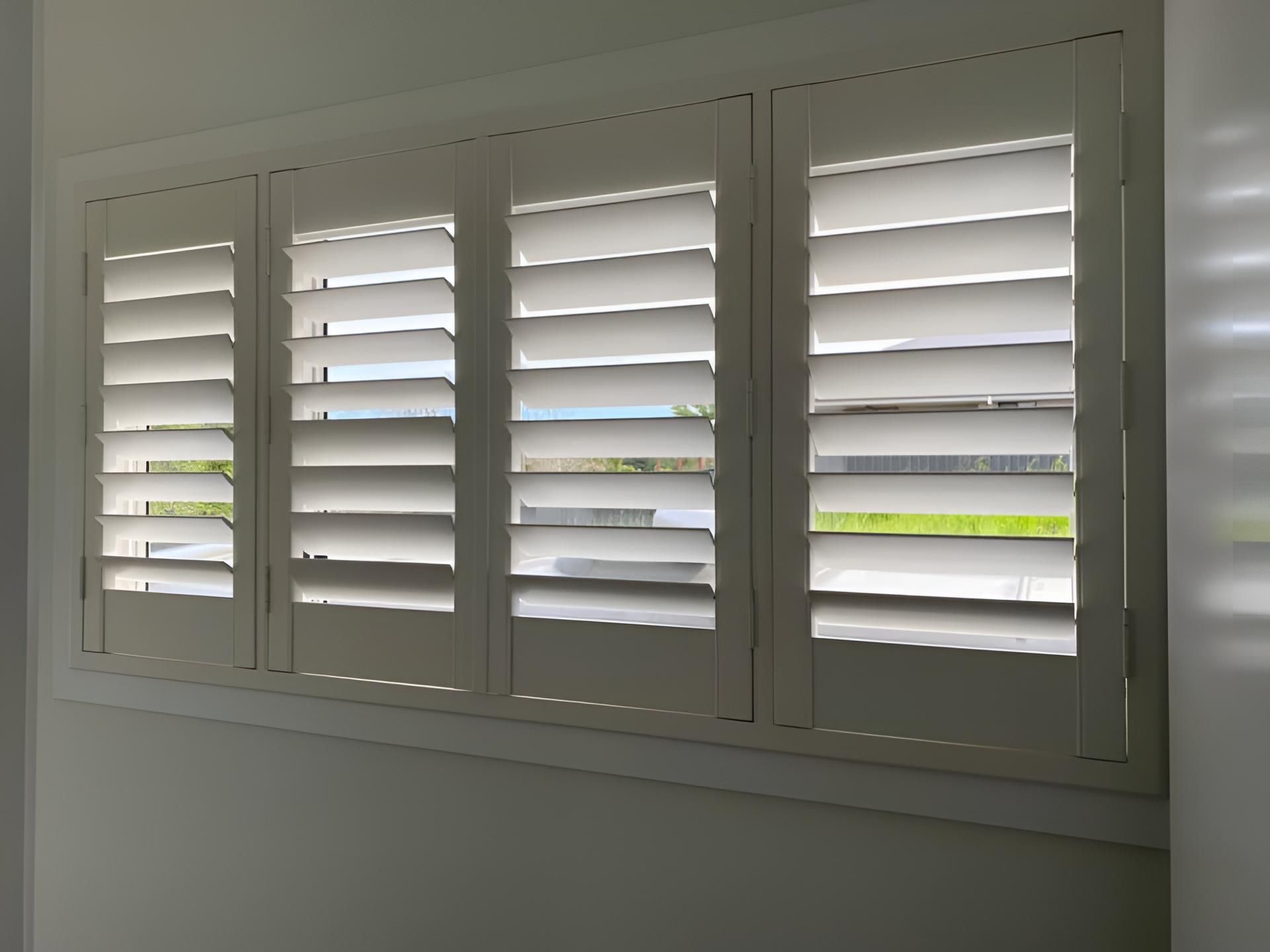 A Window With White Shutters on It in a Room — Lismore Curtains & Blinds In Ballina, NSW