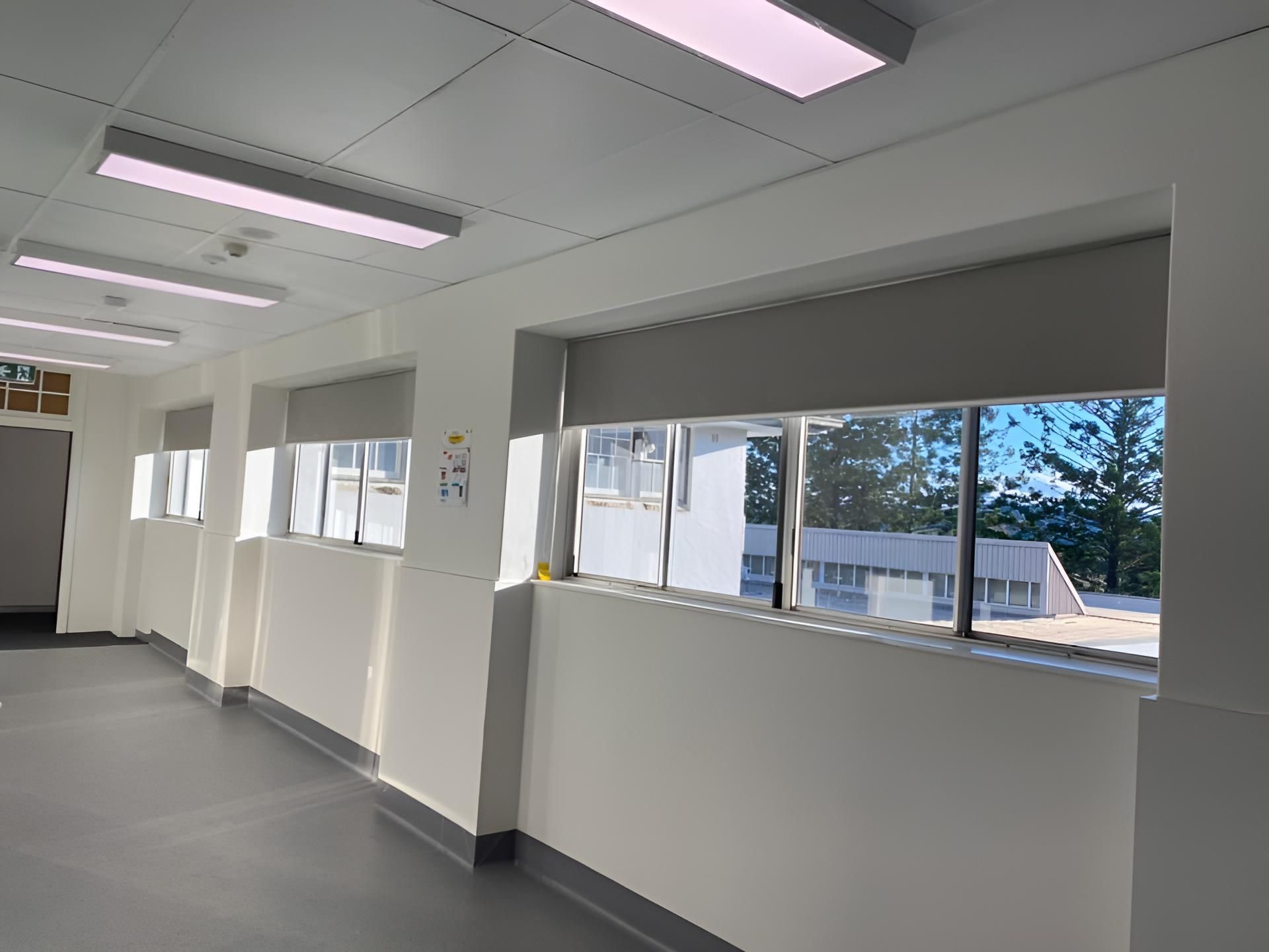 A Long Hallway With a Lot of Windows and a Ceiling Light — Lismore Curtains & Blinds In Casino, NSW