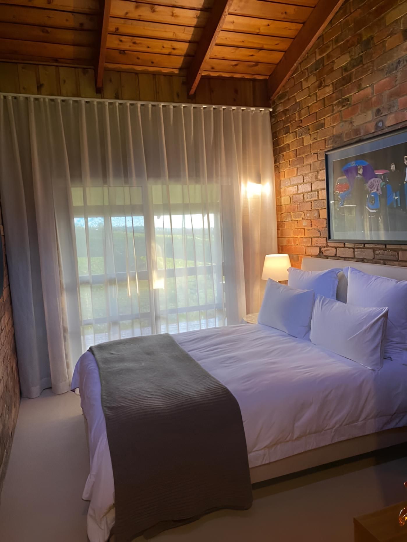 A Bedroom With a Bed, Curtains, and Brick Wall — Lismore Curtains & Blinds In Casino, NSW