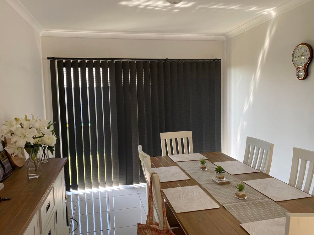 Dinning Room With Black Vertical Blinds