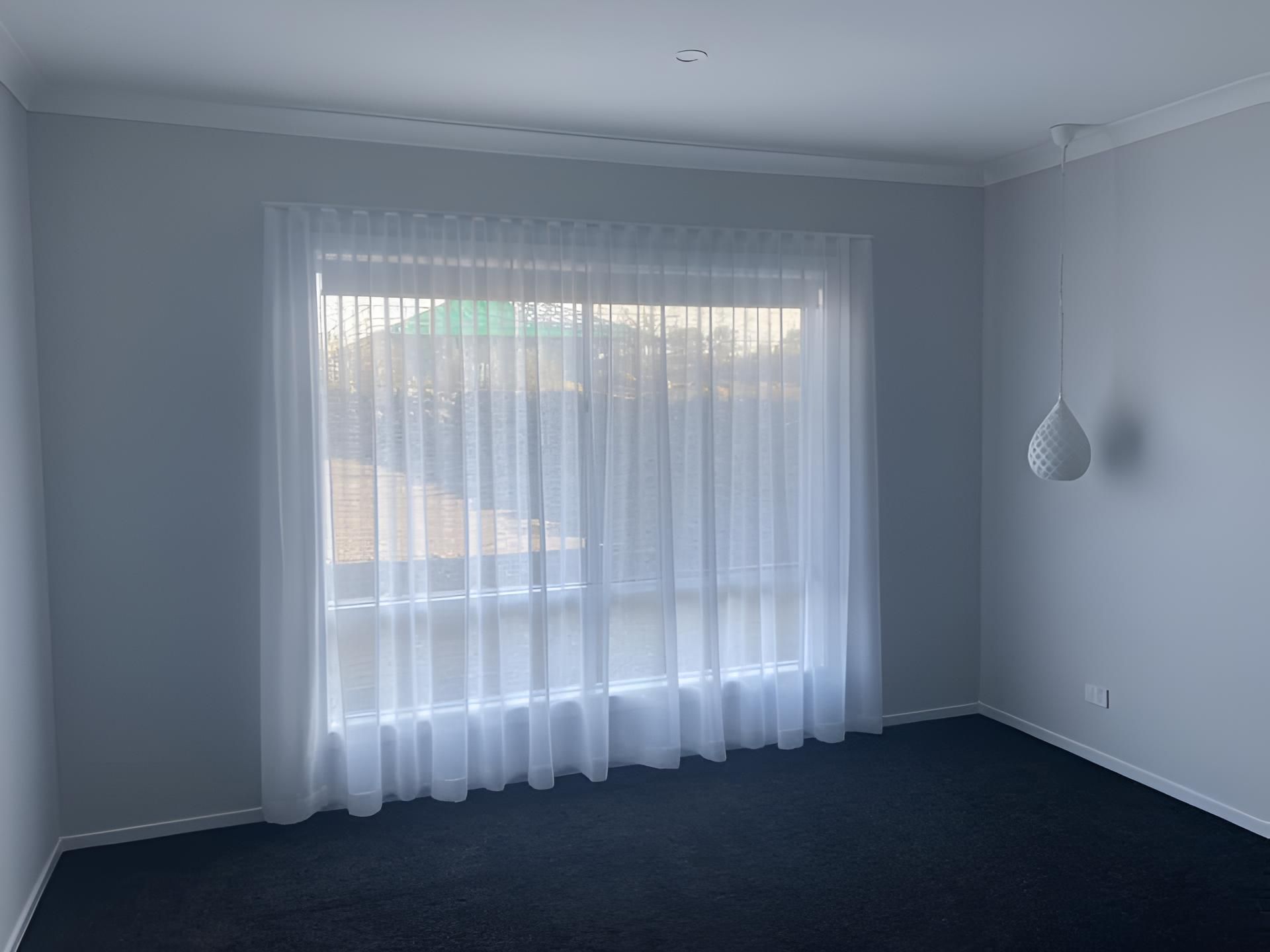 A Bedroom With a Large Window and White Curtains — Lismore Curtains & Blinds In Lismore, NSW