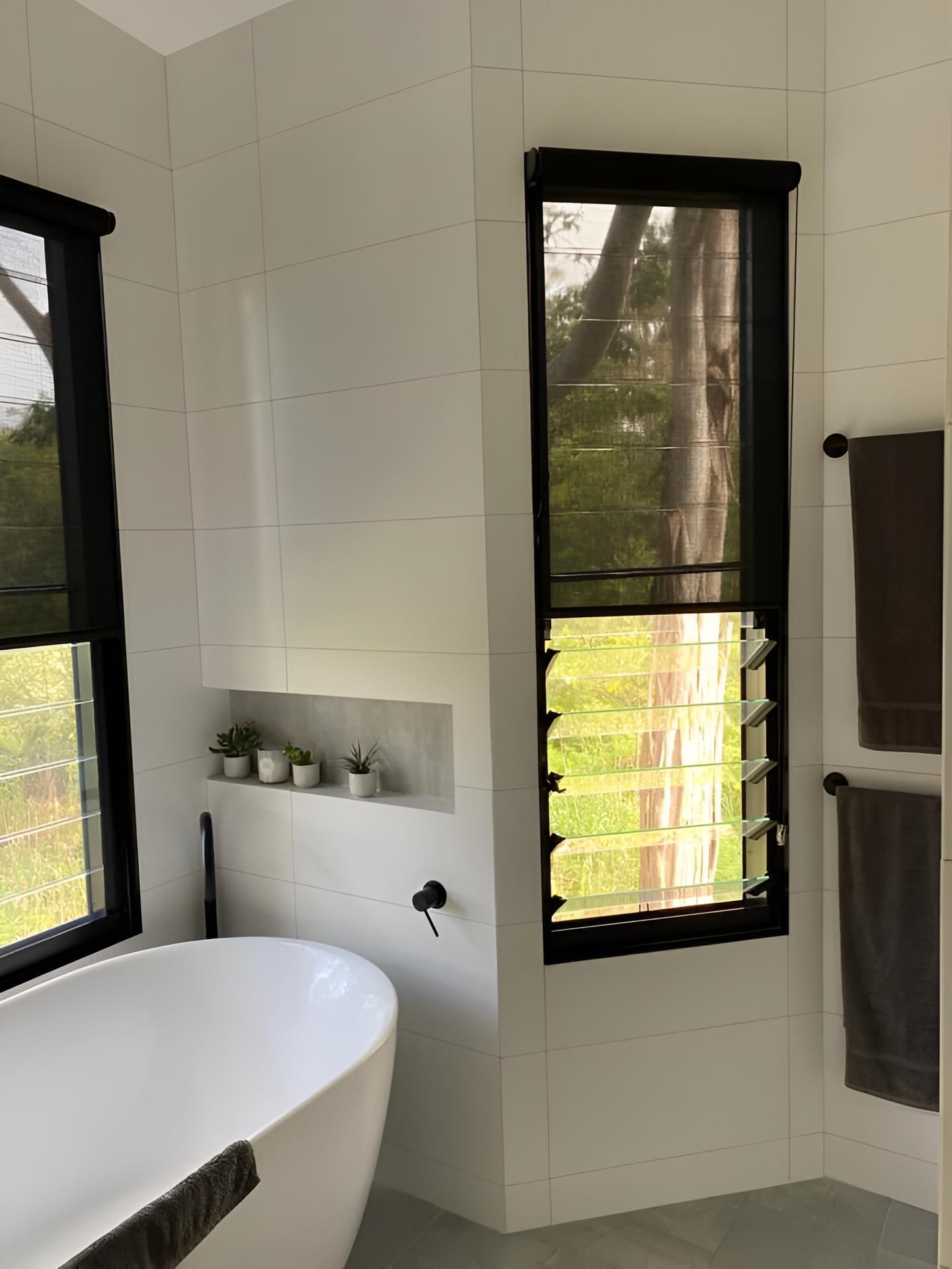 A Bathroom With a Bathtub and Two Windows — Lismore Curtains & Blinds In Lismore, NSW