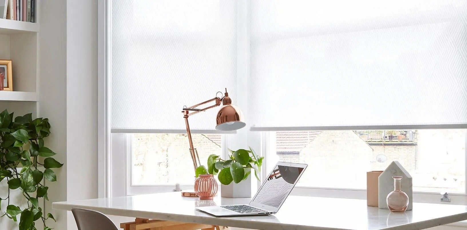 A Desk With a Laptop and a Lamp on It in Front of a Window — Lismore Curtains & Blinds In Lismore, NSW