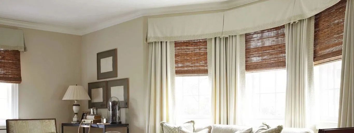 A Living Room With a Couch, Chairs, Lamps and Wicker Curtains — Lismore Curtains & Blinds In Lismore, NSW