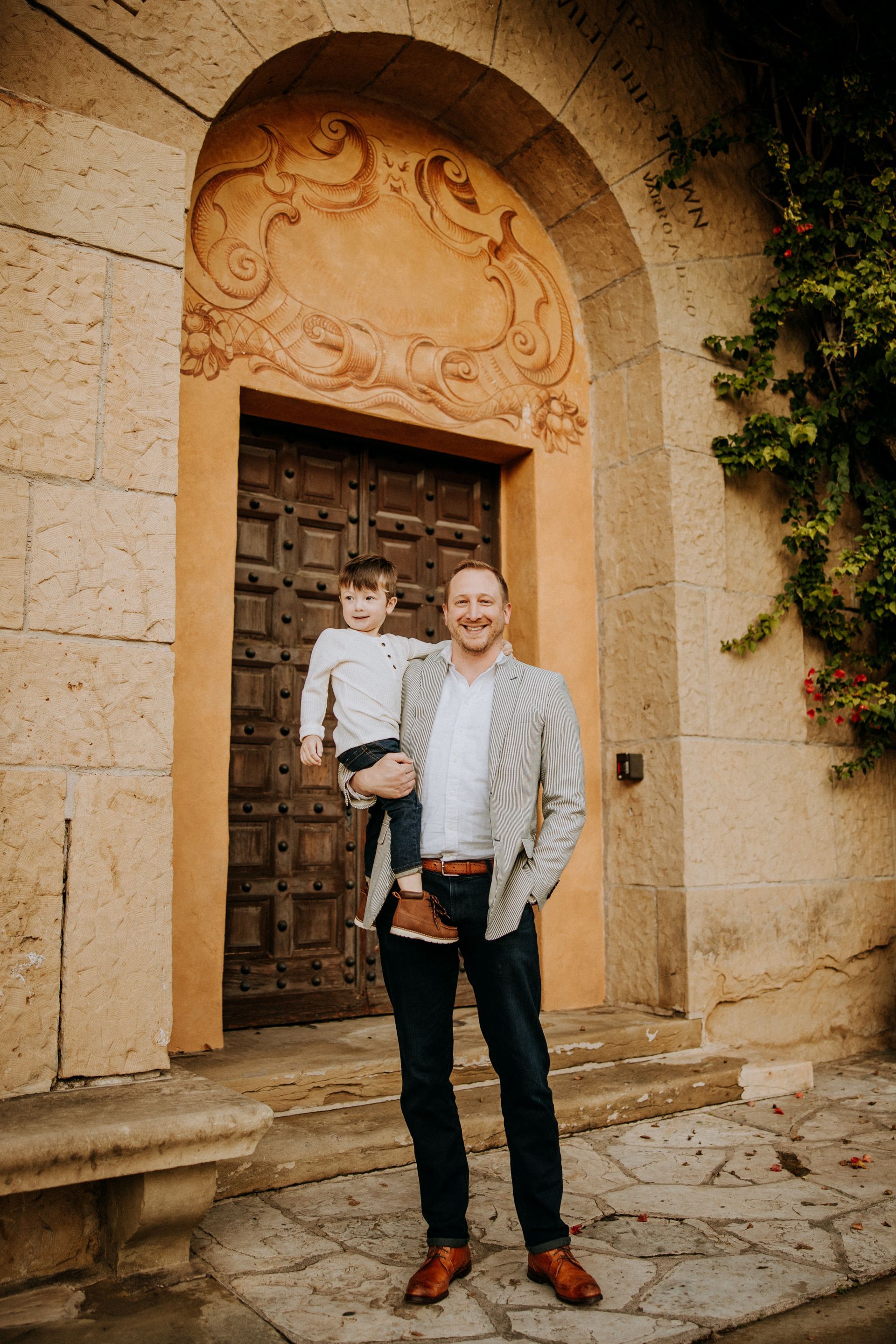 Steven Vorholt smiling and standing with his young son.