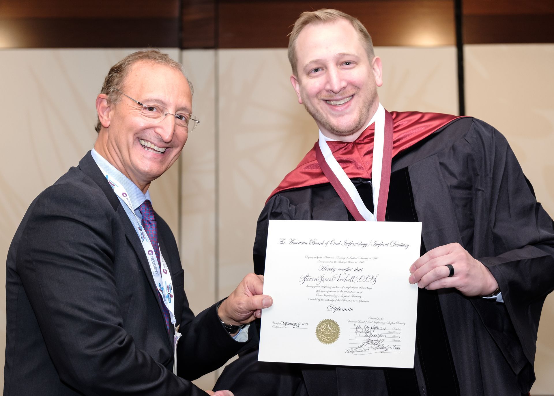 Steven Vorholt holding his diploma for his DABOI credential.
