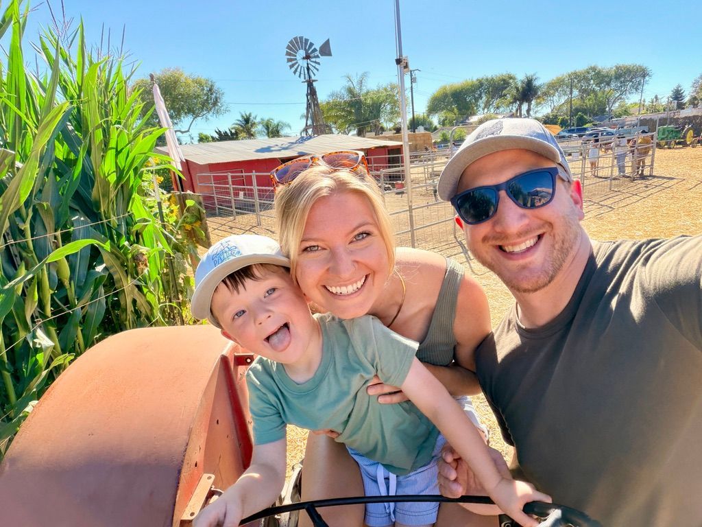 Steven Vorholt smiling at the camera with his son and partner.