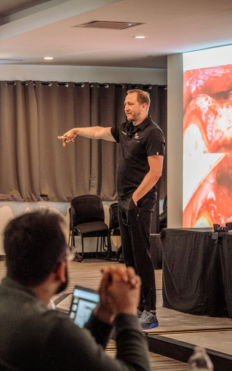 Steven Vorholt speaking to an audience with a photo from a case projected behind him.