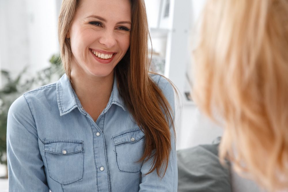 Smiling Woman Talking to her Therapist — Therapeutic Interventions in Cairns QLD