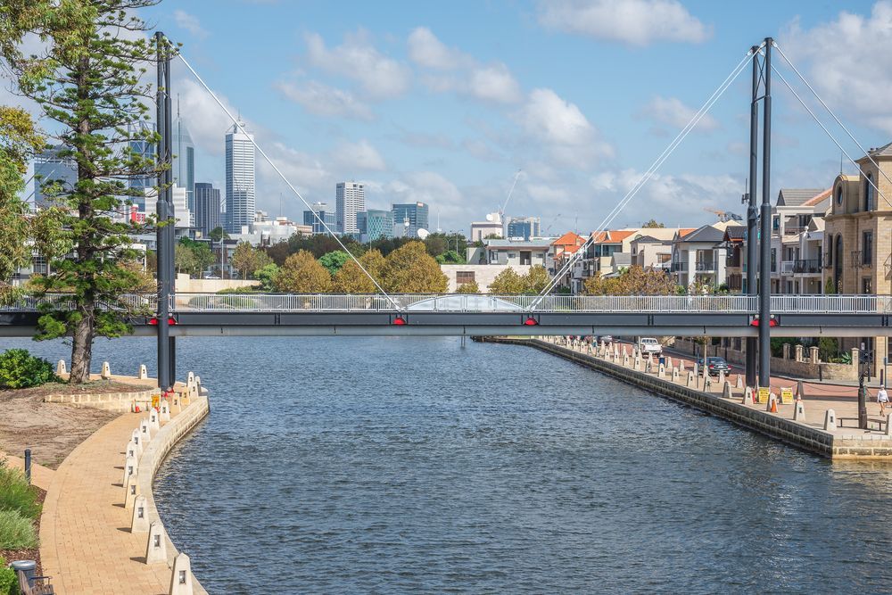 A Bridge Over a Body of Water With a City in the Background — Thrive Therapy Solutions in Perth, WA