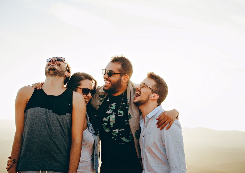 A Group of Young People Are Standing Next to Each Other and Laughing — Thrive Therapy Solutions in Wembley Downs, WA