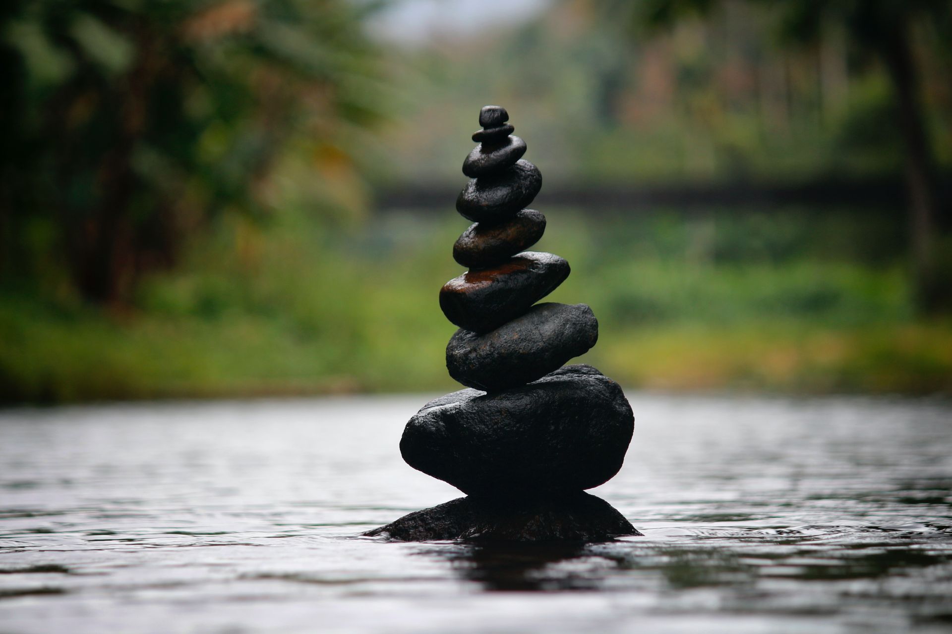 A pile of rocks stacked on top of each other in the water -Holistic Therapist in Cairns QLD