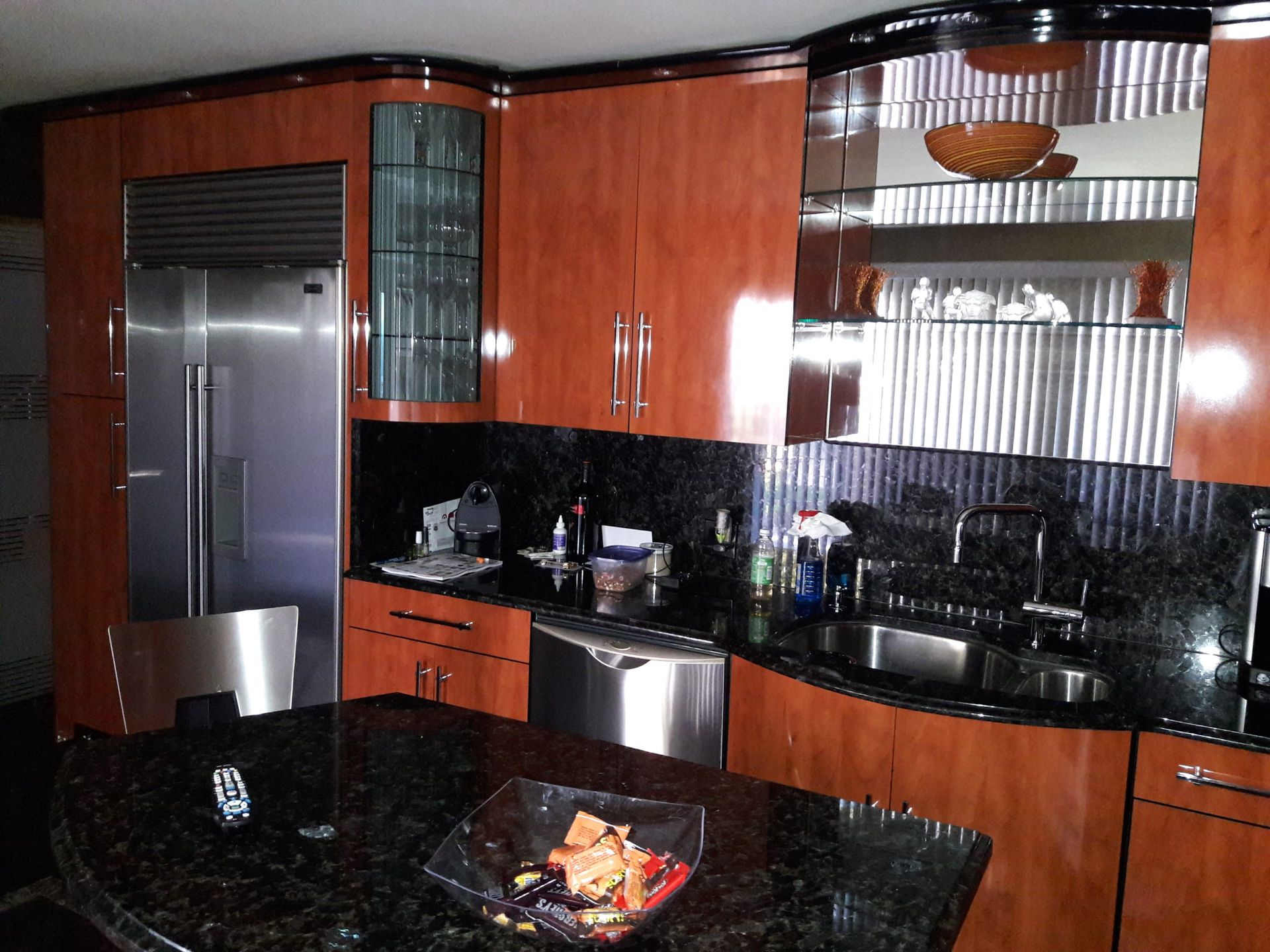 Kitchen with wood cabinets, stainless steel appliances, and dark granite countertops.