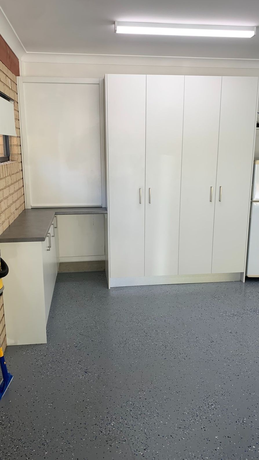 A Kitchen With White Cabinets and a Gray Floor — The Kitchen Centre In Tuggerah, NSW