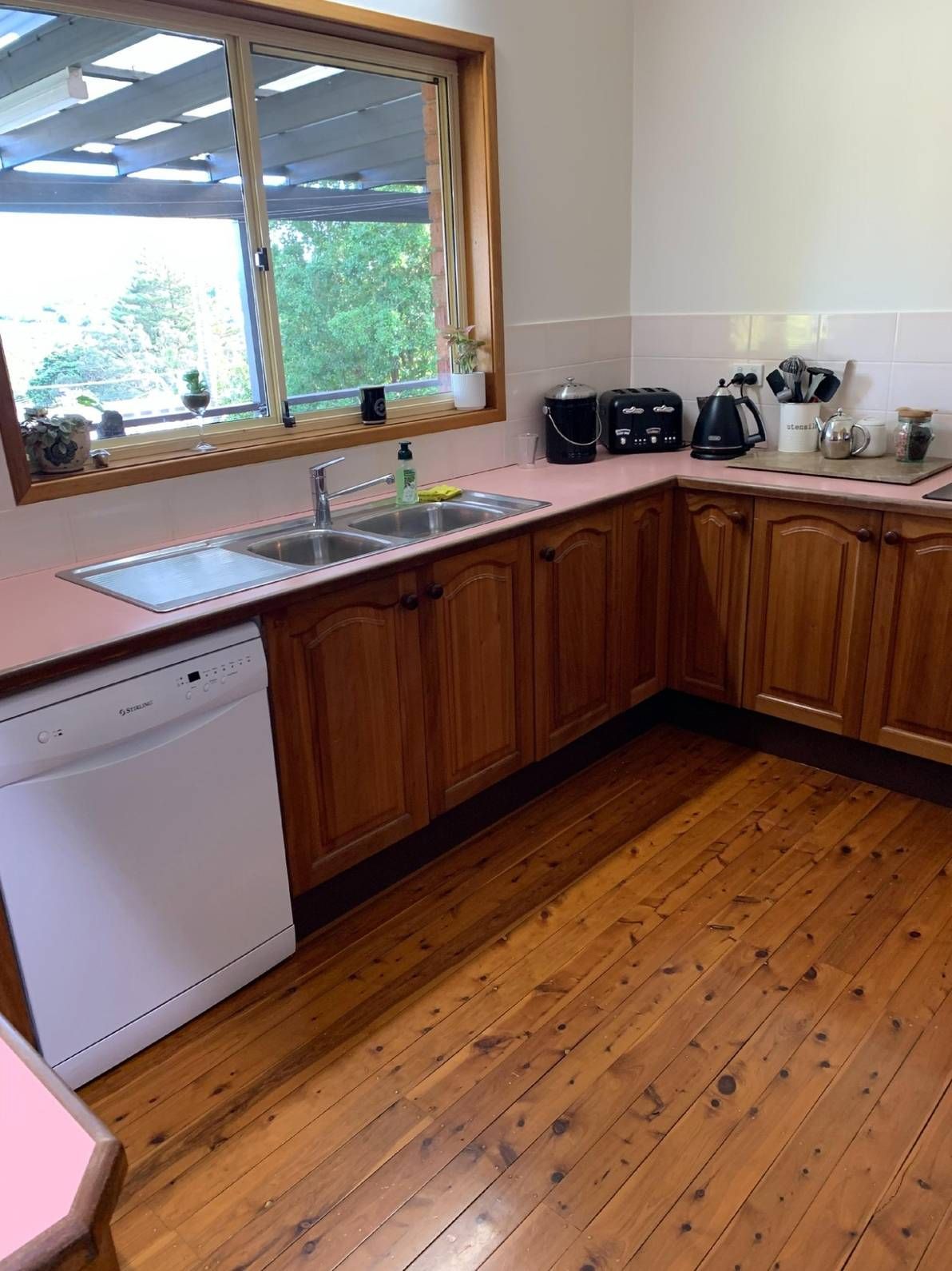 A Kitchen With Wooden Cabinets and a White Dishwasher — The Kitchen Centre In Erina, NSW