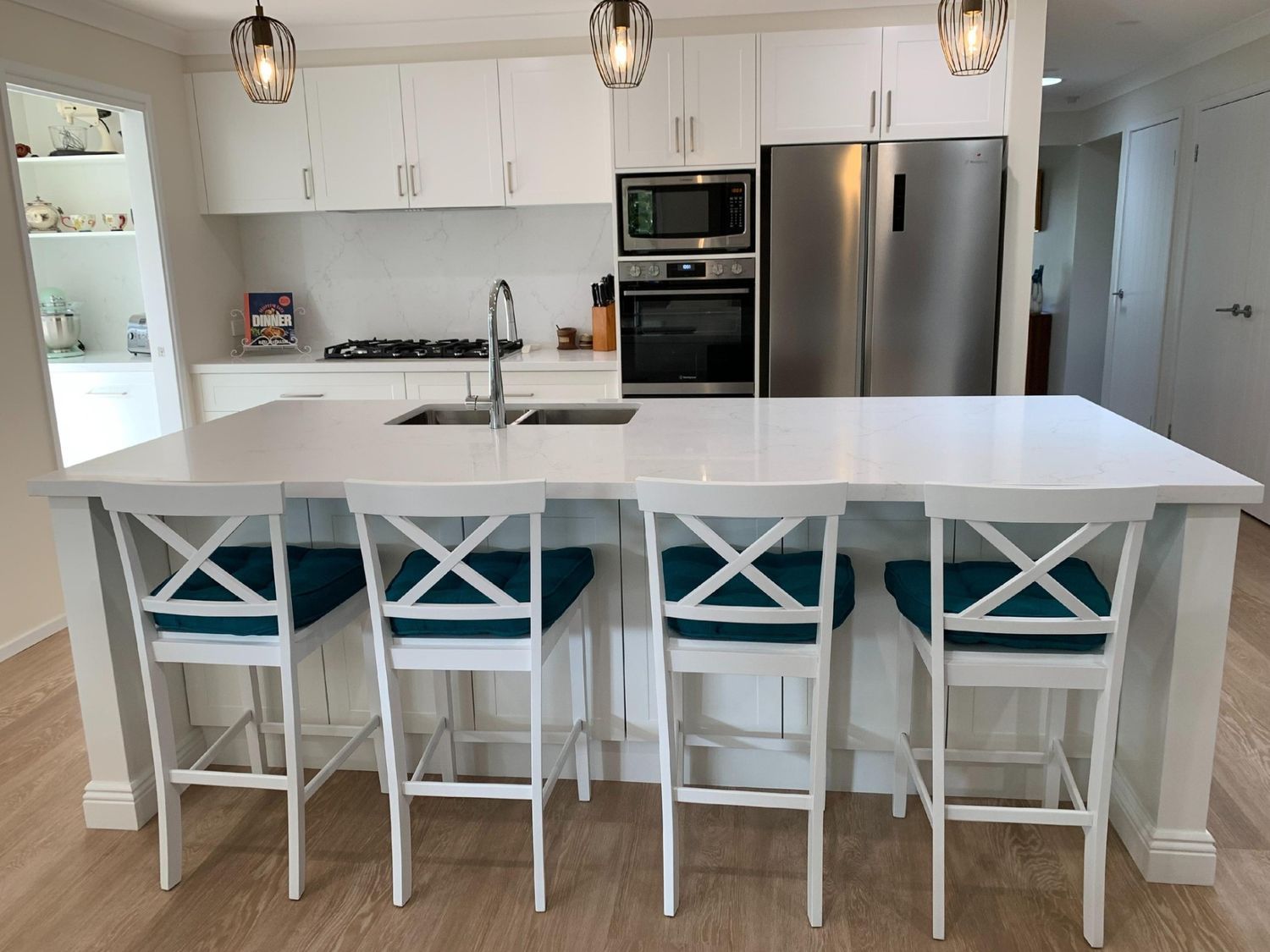 A Kitchen With White Cabinets and a Stainless Steel Refrigerator — The Kitchen Centre In Gosford, NSW