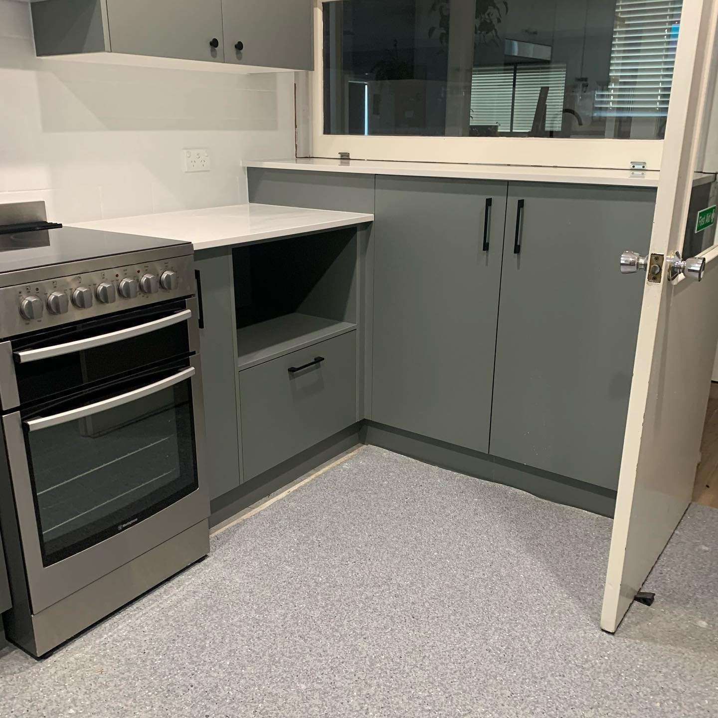 A Kitchen With a Stove, Oven, Cabinets and a Window — The Kitchen Centre In The Entrance, NSW