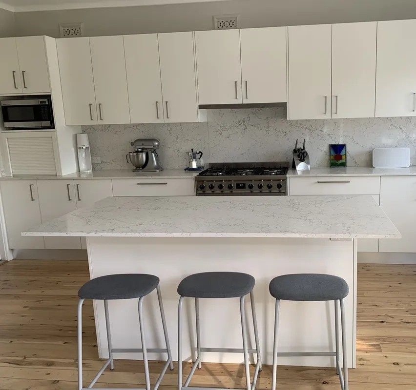 A Kitchen With White Cabinets and a Stove Top Oven — The Kitchen Centre In Tuggerah, NSW
