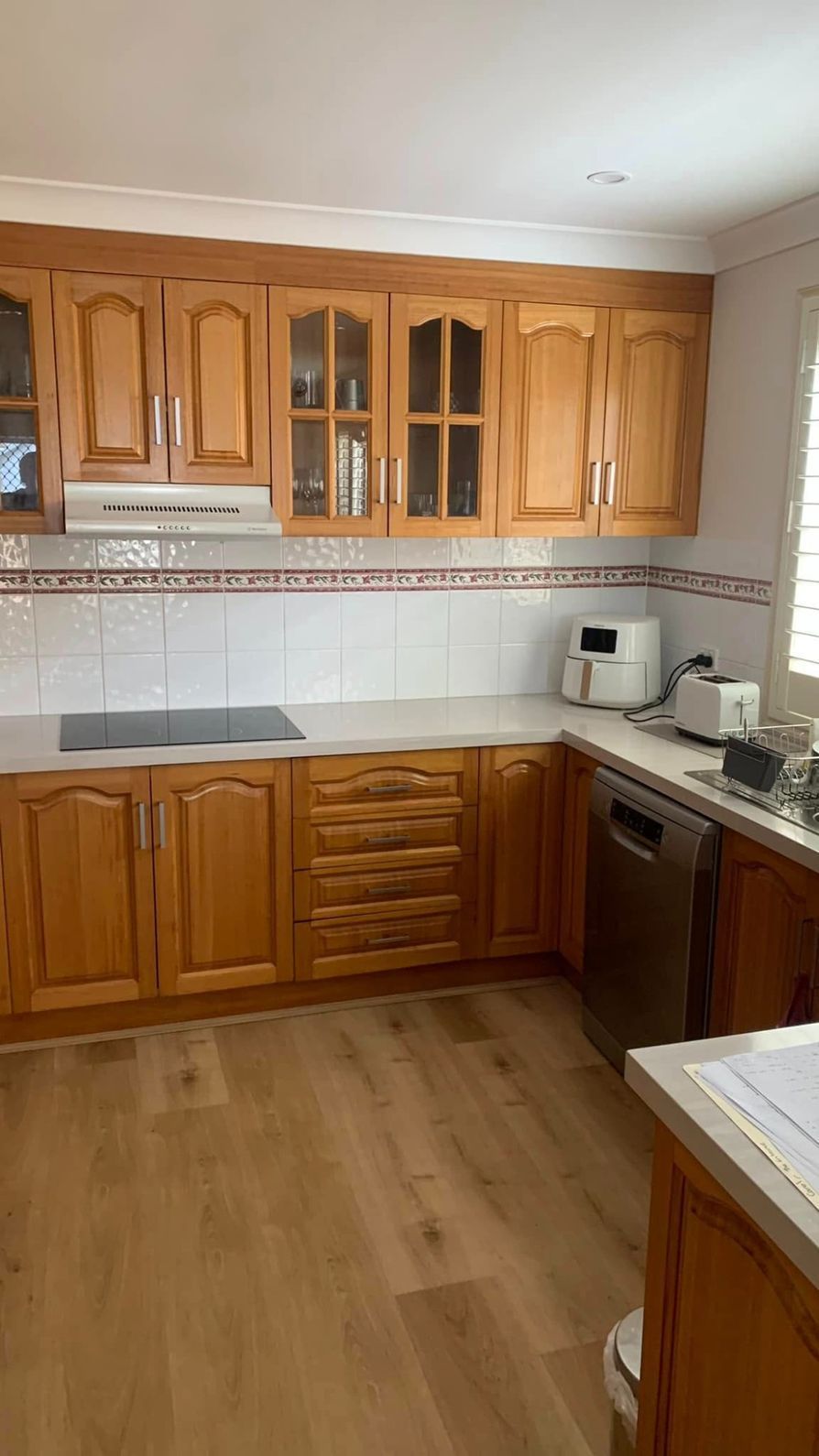 A Kitchen With Wooden Cabinets and a Stove Top Oven — The Kitchen Centre in Terrigal, NSW