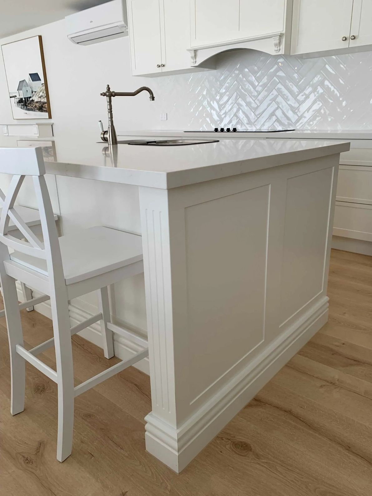 A Kitchen With White Cabinets With a Sink and Chairs — The Kitchen Centre In Tuggerah, NSW