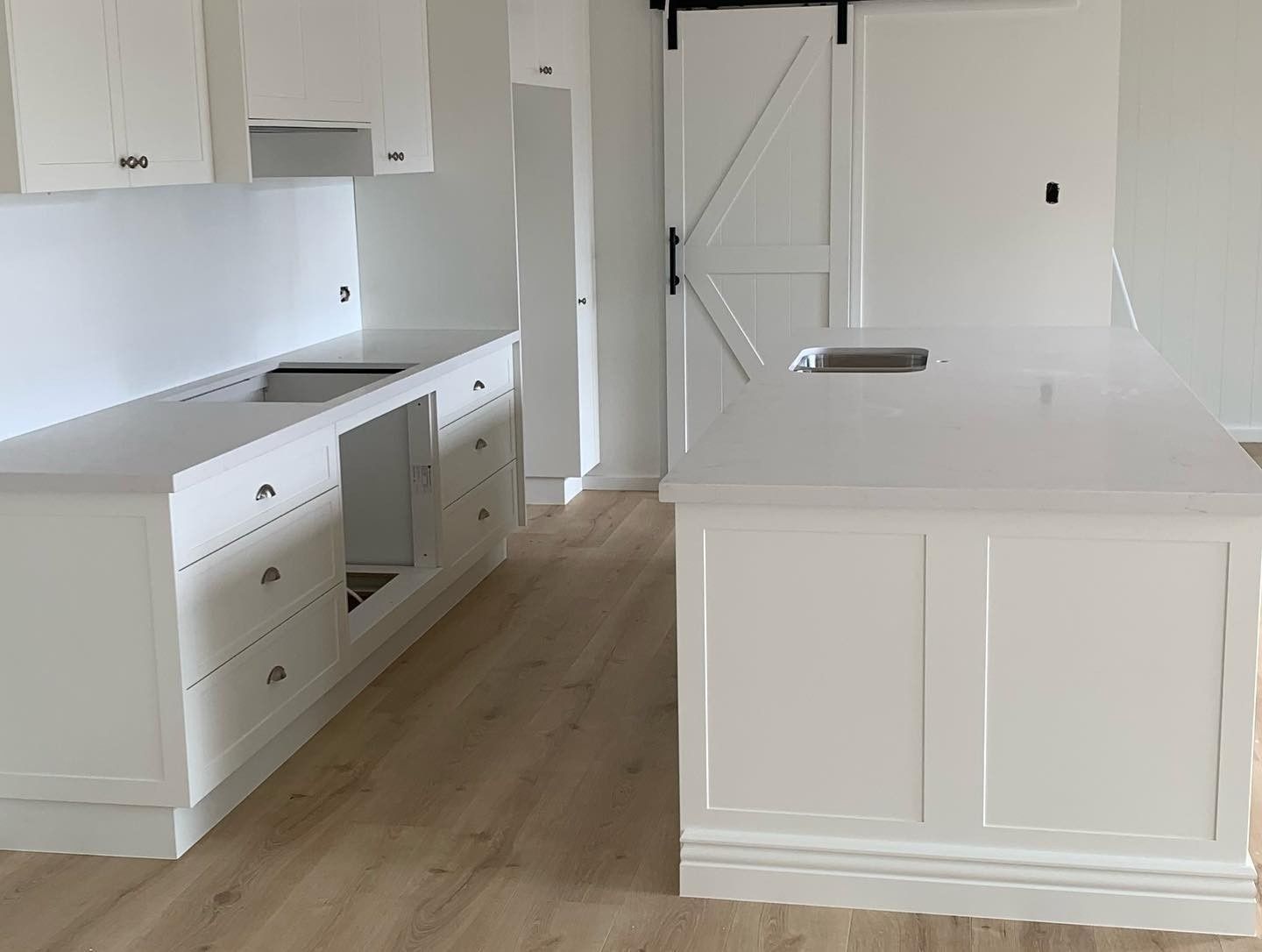 A Kitchen With White Cabinets and a Large Island — The Kitchen Centre In The Entrance, NSW