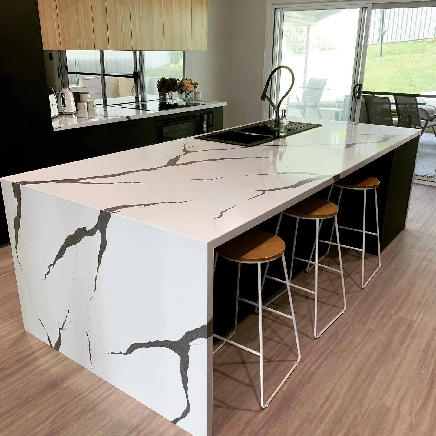 A Kitchen With a Large Island With Stools and a Sink — The Kitchen Centre In Tuggerah, NSW