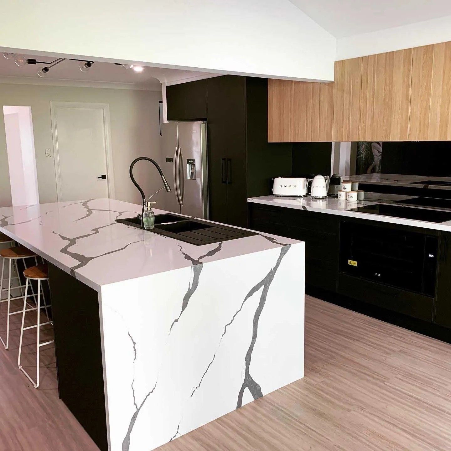 A Kitchen With a Large Island in the Middle of the Room — The Kitchen Centre In Tuggerah, NSW