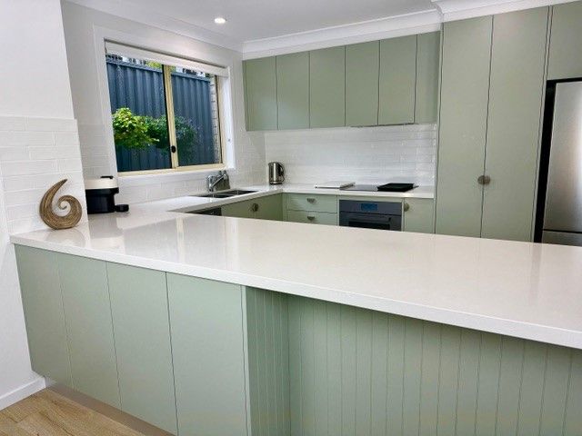 Green Kitchen With White Countertops And Wooden Floors — The Kitchen Centre In Tuggerah, NSW