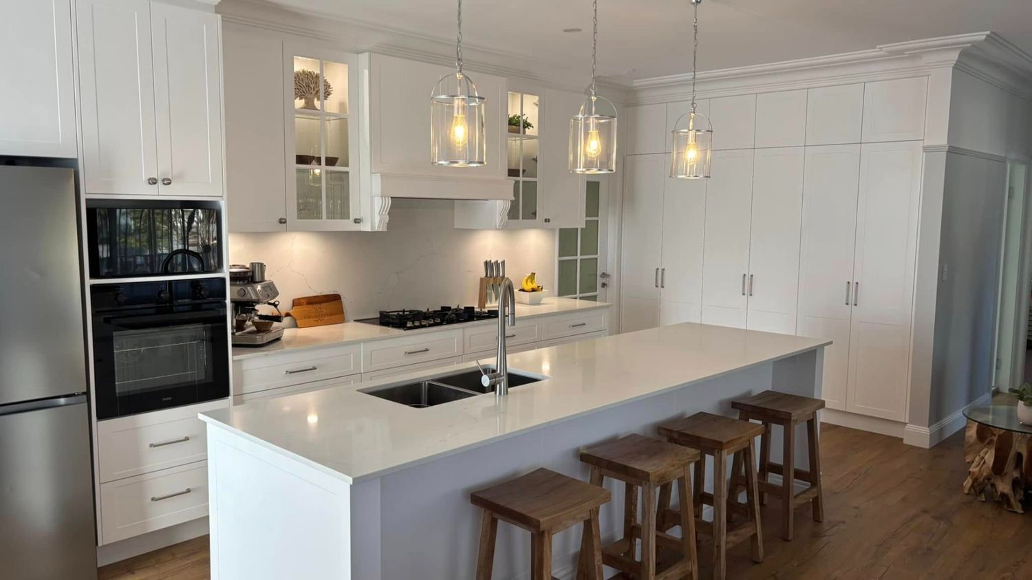 A Large Kitchen Area With Black Oven and Refrigerator — The Kitchen Centre in Terrigal, NSW