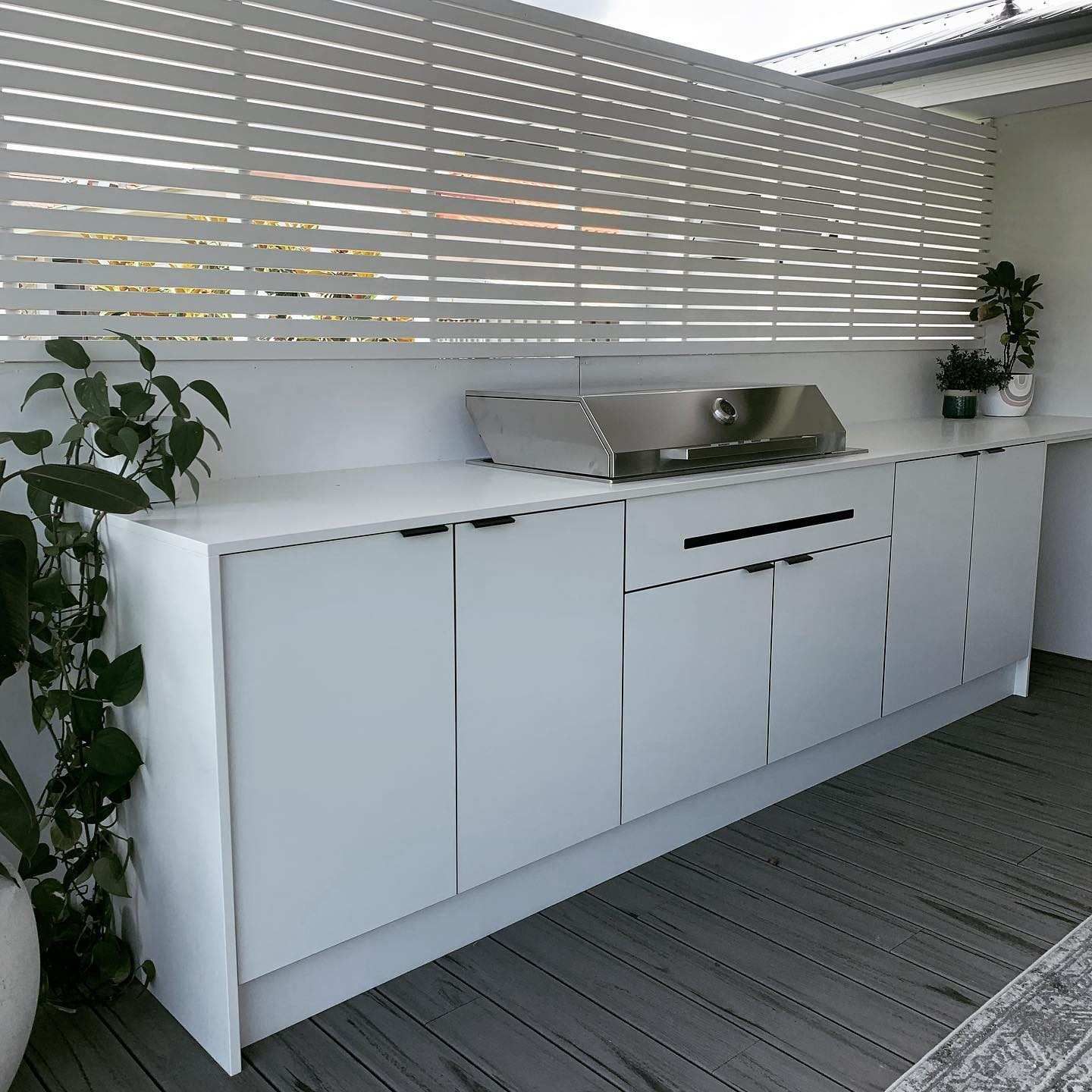 A Kitchen With White Cabinets and a Grill on the Counter — The Kitchen Centre In Wyong, NSW