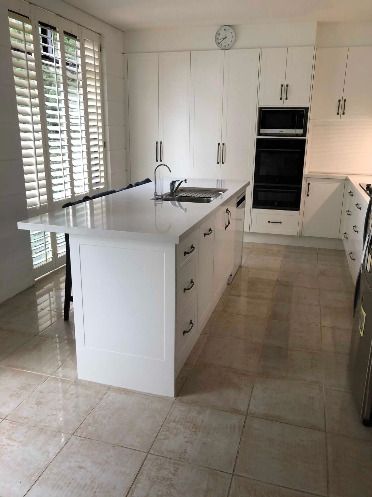 A Kitchen With White Cabinets, Stainless Steel Appliances — The Kitchen Centre In Tuggerah, NSW