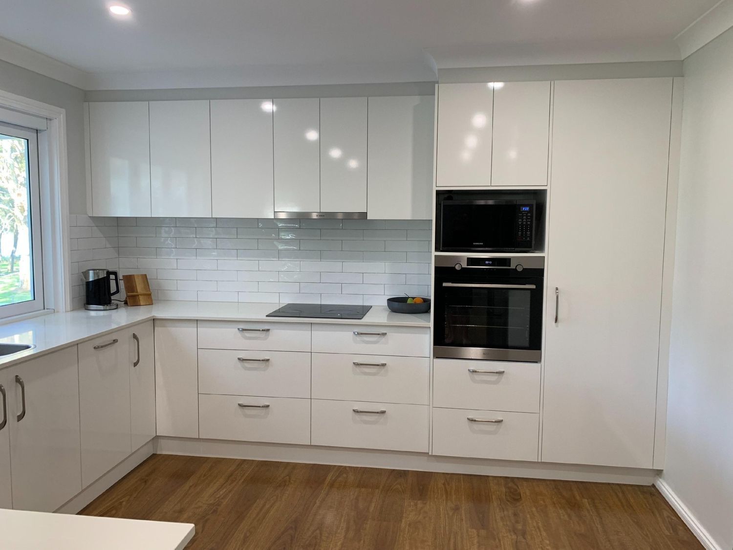 A Wide White Cabinet and Black Oven — The Kitchen Centre In Erina, NSW