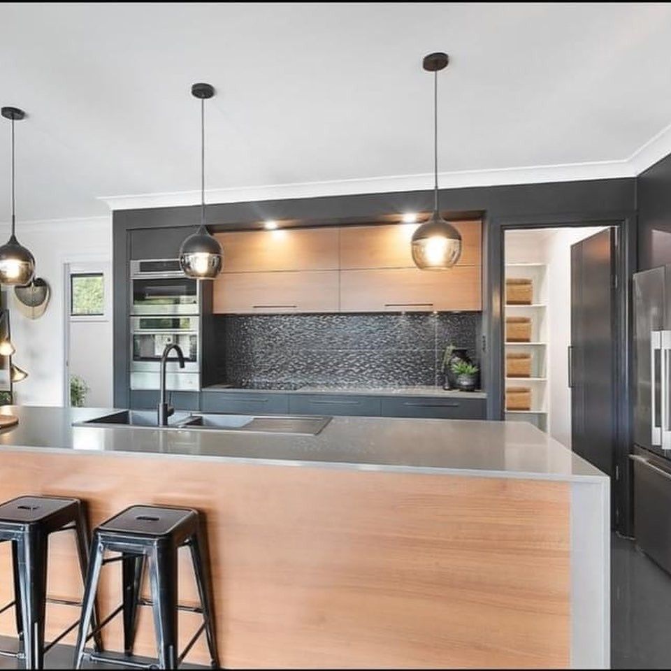 A Kitchen With Wooden Cabinets and Black Stools — The Kitchen Centre In Tuggerah, NSW