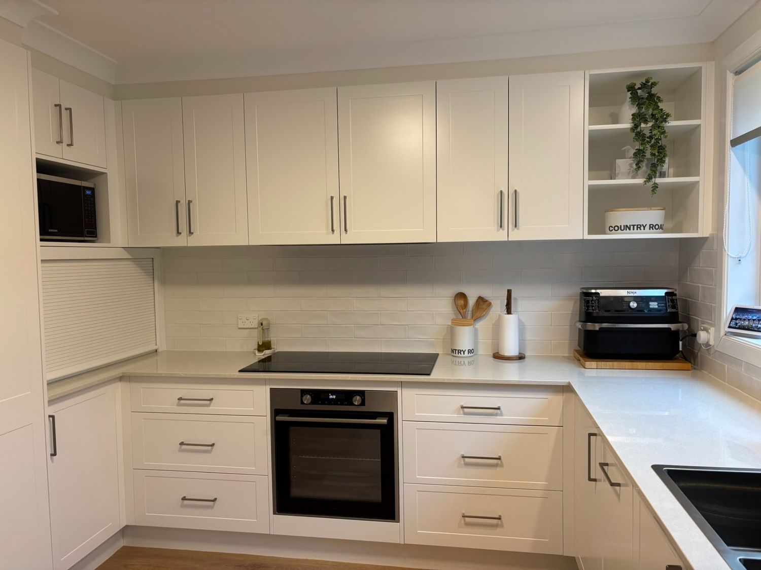 There Are Many Bottles of Alcohol on the Shelves in the Kitchen — The Kitchen Centre In Tuggerah, NSW