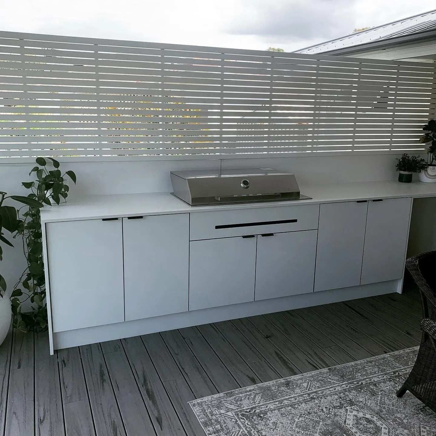 A White Kitchen With a Grill on a Wooden Deck — The Kitchen Centre In Tuggerah, NSW