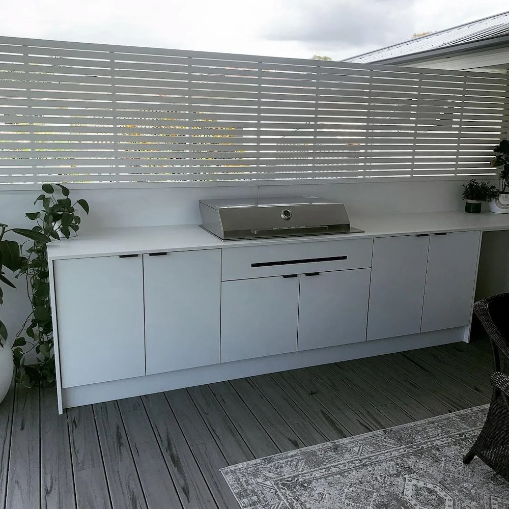 Outdoor White Kitchen With Grill, Cabinets, and Wooden Deck; Slatted Privacy Screen — The Kitchen Centre In Tuggerah, NSW