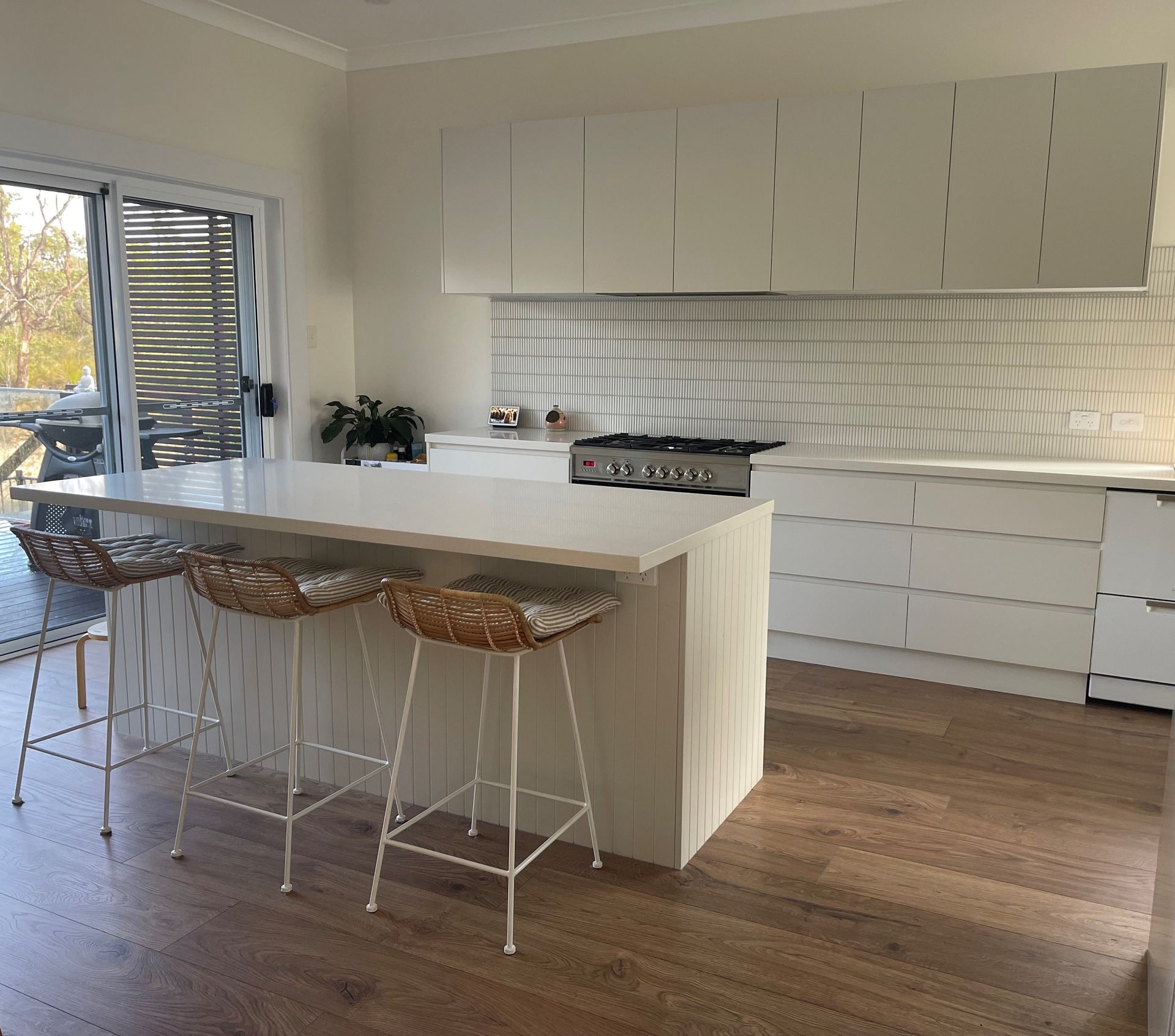 Modern White Kitchen With Island and Stools — The Kitchen Centre In Tuggerah, NSW