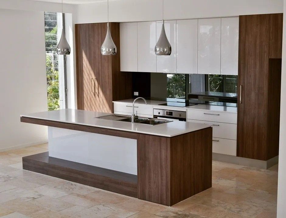 A Kitchen With a Large Island and White Cabinets — The Kitchen Centre In Tuggerah, NSW