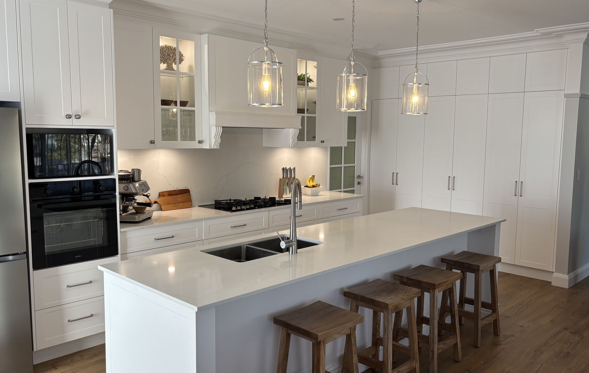 Modern White Kitchen With Island and Stools — The Kitchen Centre In Tuggerah, NSW