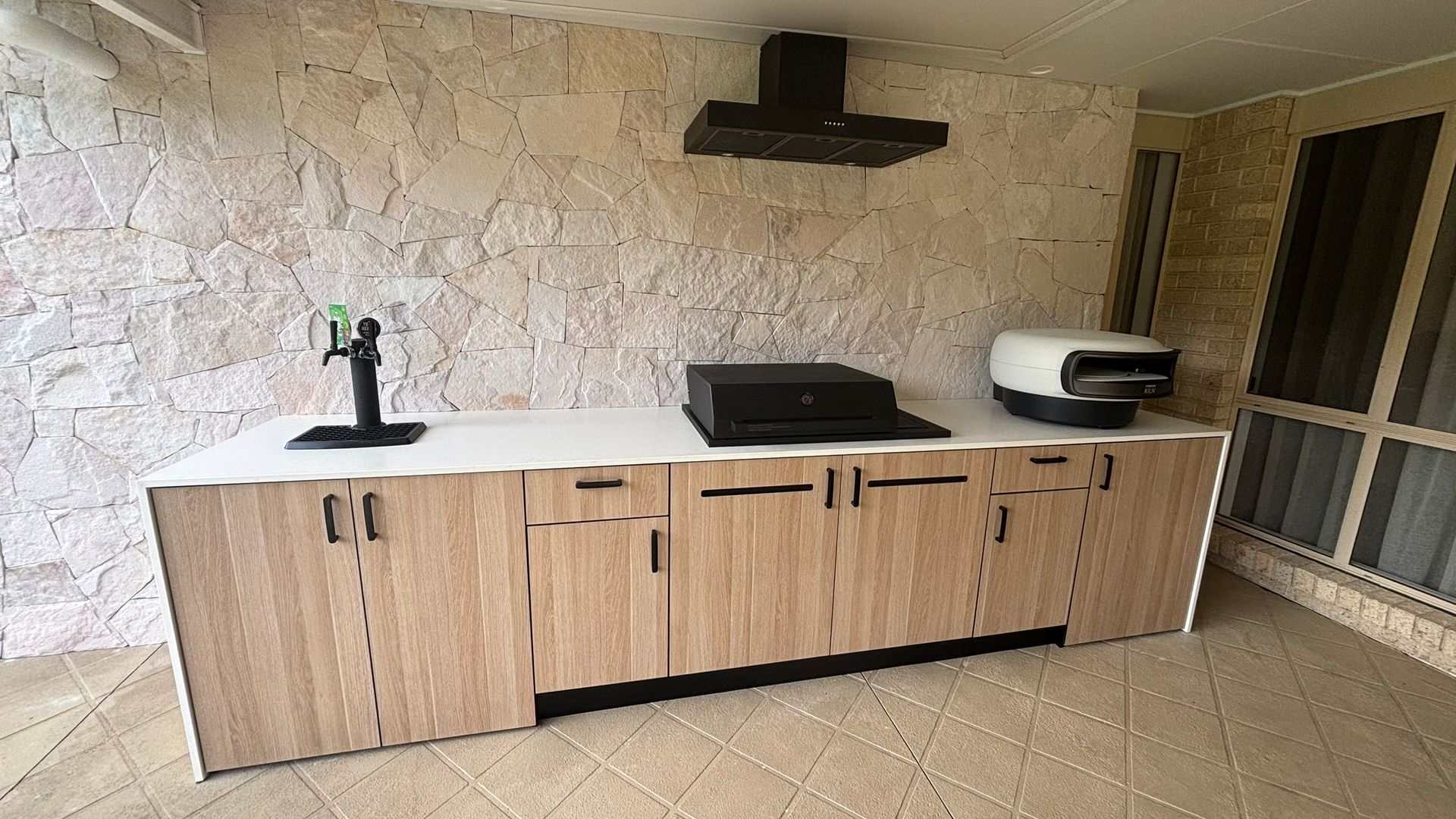 Outdoor Barbecue With Wood Cabinets and White Countertop — The Kitchen Centre In Tuggerah, NSW