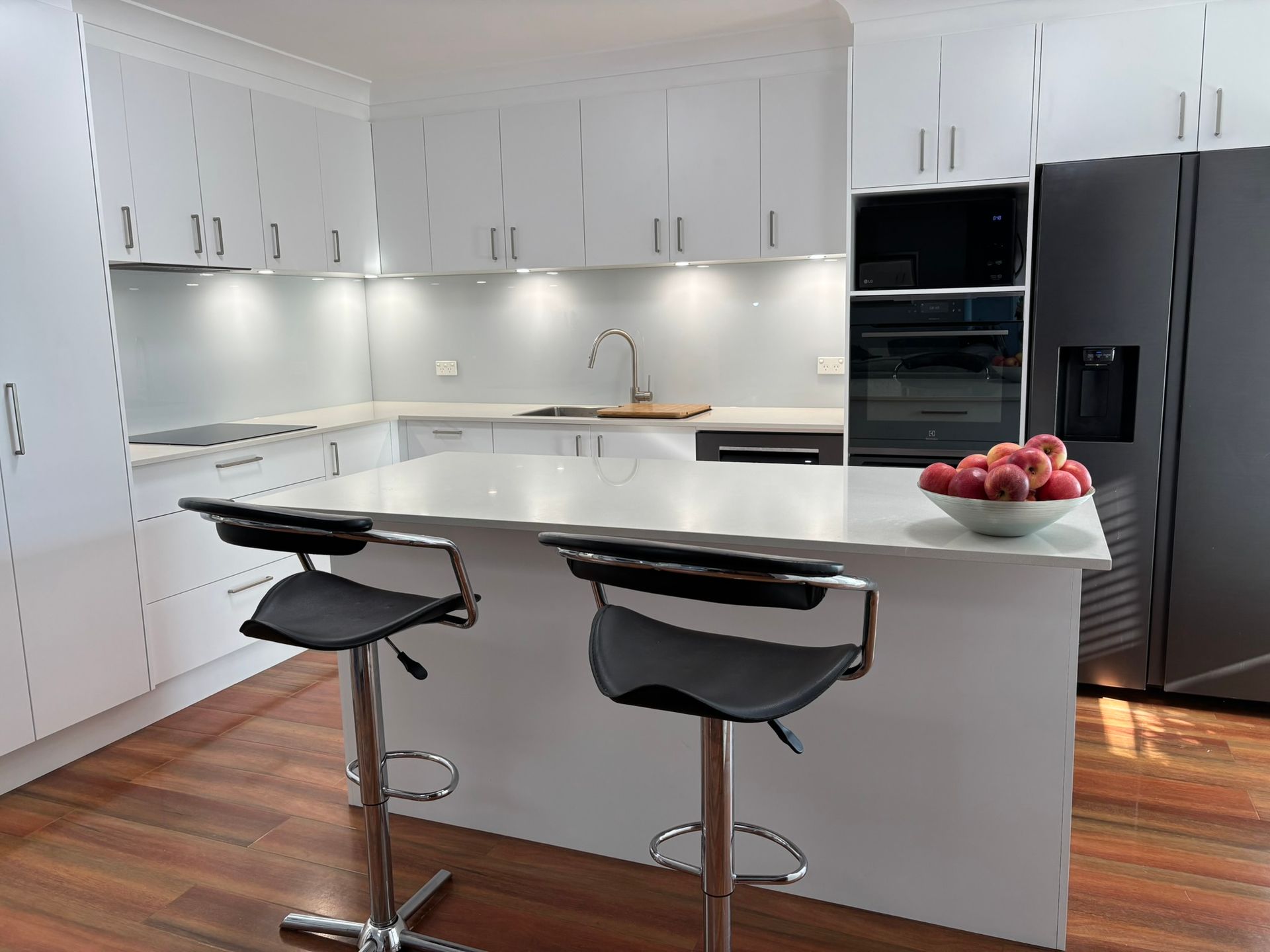 Modern White Kitchen With Island and Stools — The Kitchen Centre In Tuggerah, NSW