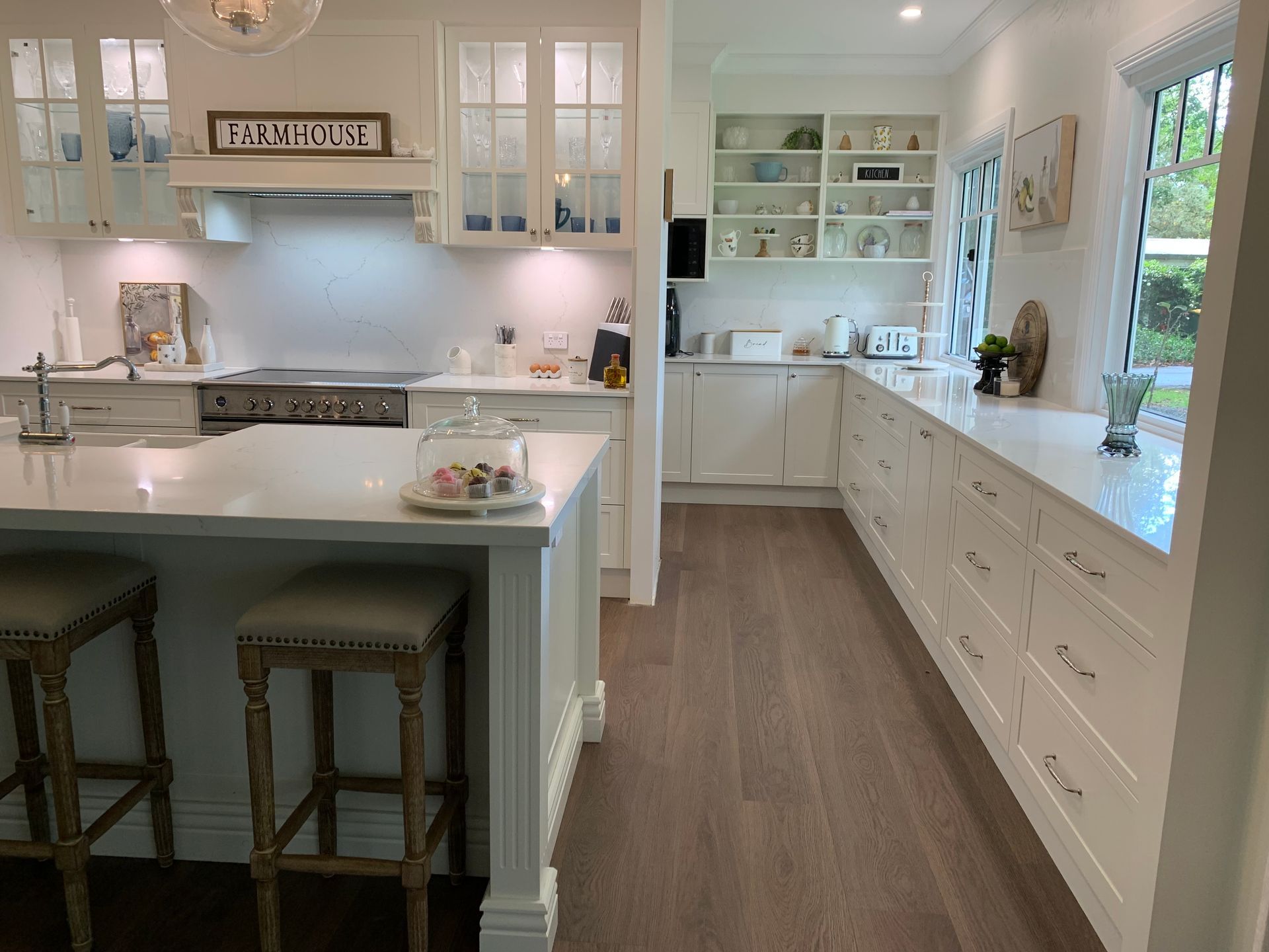 Green Kitchen With White Countertops, Stools, And Wooden Floors — The Kitchen Centre In Tuggerah, NSW